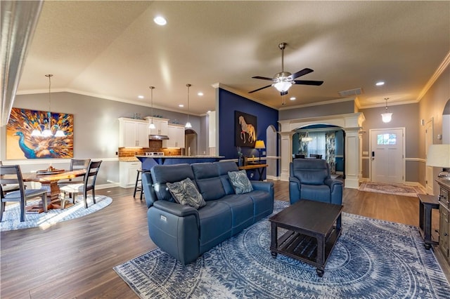 2444 Poole Rd, Greer, SC 29650 - living area with arched walkways, a ceiling fan, dark wood-style flooring, crown molding, and ornate columns
