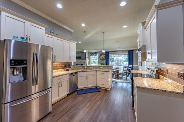 2444 Poole Rd, Greer, SC 29650 - kitchen featuring appliances with stainless steel finishes, a peninsula, crown molding, backsplash, and dark wood finished floors