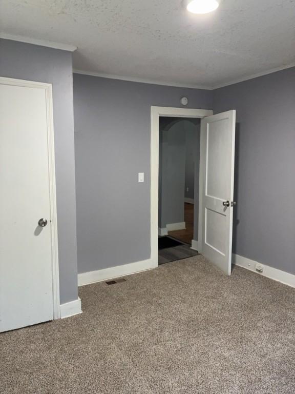 715 Delia St, Anderson, SC 29624 - carpeted spare room with ornamental molding, a smoke detector, and a textured ceiling