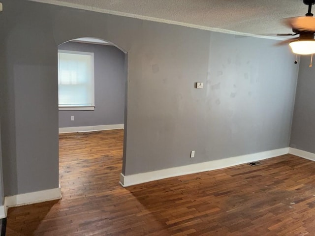 715 Delia St, Anderson, SC 29624 - empty room featuring arched walkways, ceiling fan, wood finished floors, a textured ceiling, and ornamental molding