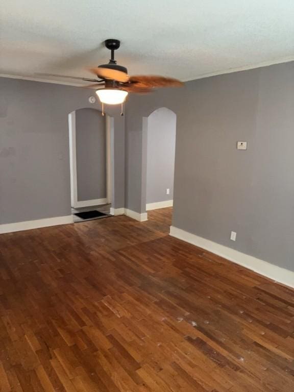 715 Delia St, Anderson, SC 29624 - empty room featuring arched walkways, crown molding, a ceiling fan, and wood finished floors