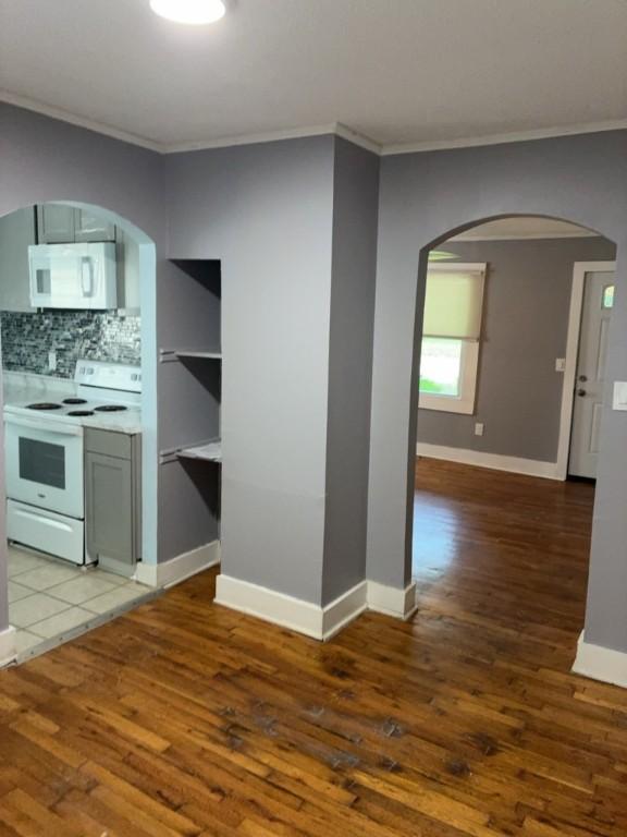 715 Delia St, Anderson, SC 29624 - kitchen featuring white appliances, arched walkways, crown molding, and wood finished floors