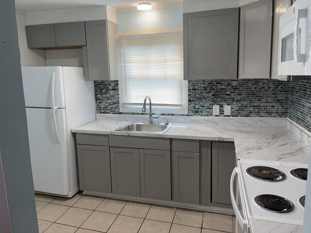 715 Delia St, Anderson, SC 29624 - kitchen with white appliances, gray cabinets, tasteful backsplash, and light tile patterned floors