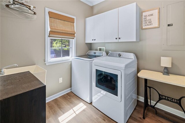 308 Amethyst Way, Seneca, SC 29672 - laundry room with cabinet space, washing machine and dryer, light wood-type flooring, and electric panel