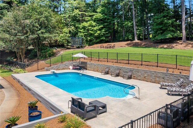 308 Amethyst Way, Seneca, SC 29672 - view of pool featuring a patio, a trampoline, a fenced backyard, a diving board, and view of wooded area