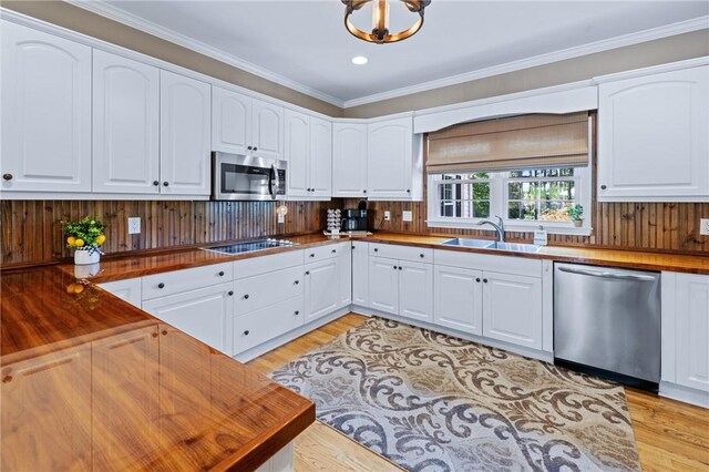 308 Amethyst Way, Seneca, SC 29672 - kitchen with appliances with stainless steel finishes, butcher block counters, light wood-style flooring, crown molding, and white cabinets