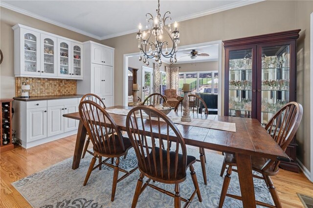 308 Amethyst Way, Seneca, SC 29672 - dining space featuring light wood-type flooring, a chandelier, ornamental molding, french doors, and ceiling fan