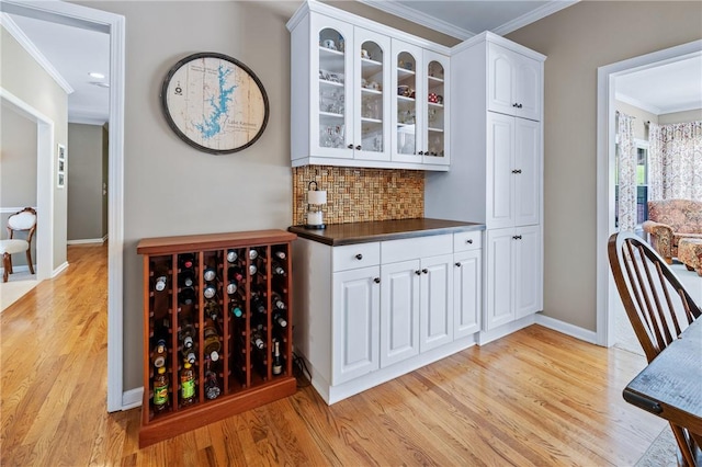 308 Amethyst Way, Seneca, SC 29672 - bar with crown molding, light wood finished floors, and tasteful backsplash