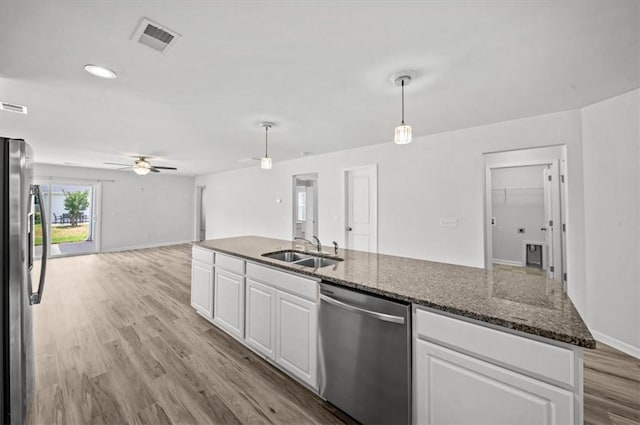 121 Traditions Blvd, Anderson, SC 29625 - kitchen featuring stainless steel appliances, white cabinets, ceiling fan, open floor plan, and light wood finished floors