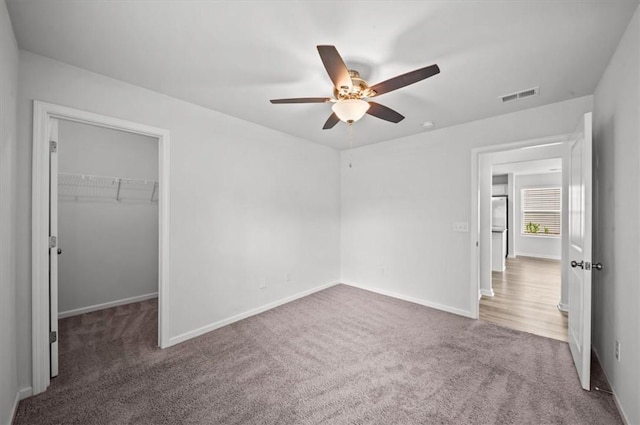 121 Traditions Blvd, Anderson, SC 29625 - unfurnished bedroom with carpet floors, a spacious closet, ceiling fan, and a closet