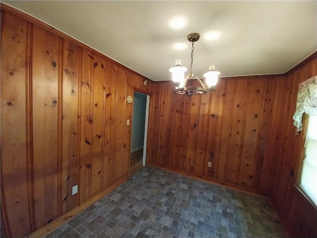202 Ashley Ave, Anderson, SC 29624 - unfurnished dining area with a chandelier, wooden walls, and stone finish flooring