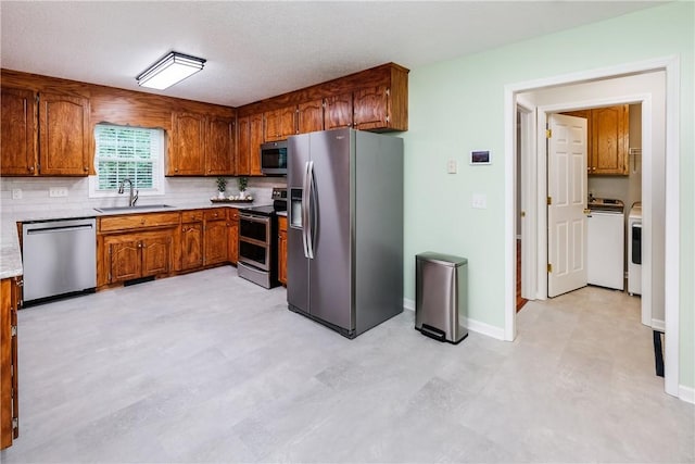 100 Crosscreek Dr, Anderson, SC 29621 - kitchen with appliances with stainless steel finishes, brown cabinetry, tasteful backsplash, light countertops, and light flooring