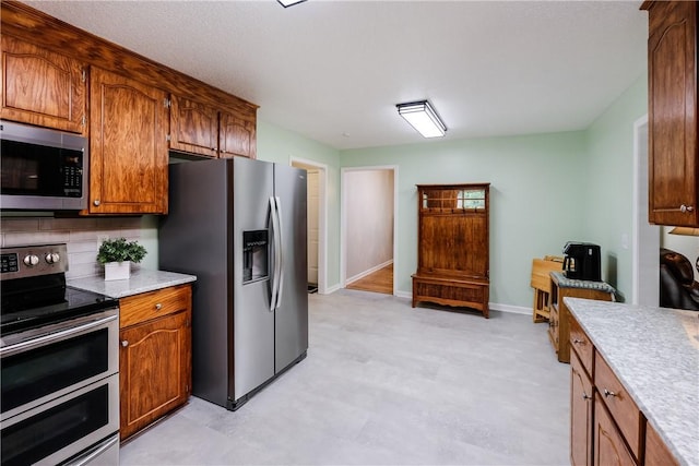 100 Crosscreek Dr, Anderson, SC 29621 - kitchen with stainless steel appliances, light flooring, light countertops, and brown cabinetry