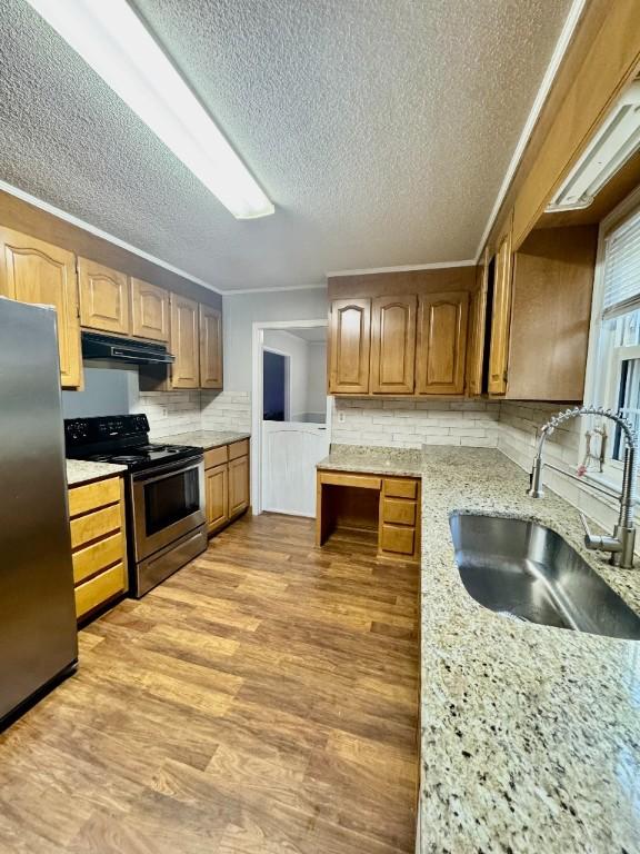 204 Payne Ln, Clemson, SC 29631 - kitchen featuring appliances with stainless steel finishes, extractor fan, a textured ceiling, light wood-style floors, and decorative backsplash