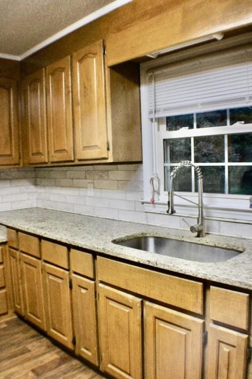 204 Payne Ln, Clemson, SC 29631 - kitchen featuring light stone countertops, dark wood-style floors, brown cabinetry, and tasteful backsplash