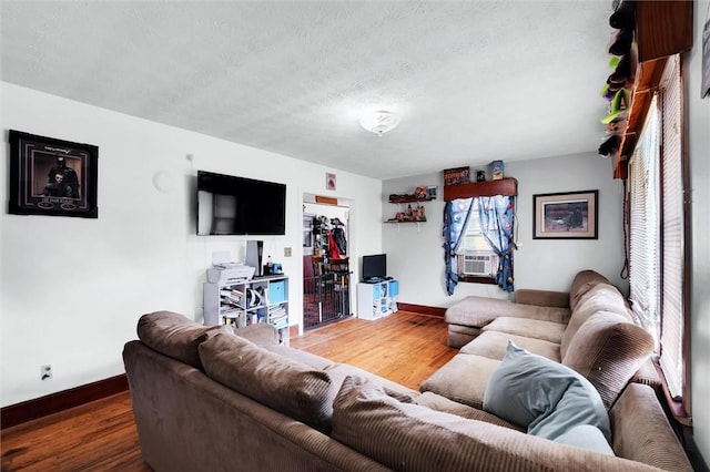 7703 Moorefield Memorial Hwy, Liberty, SC 29657 - living room with wood finished floors, cooling unit, and a textured ceiling