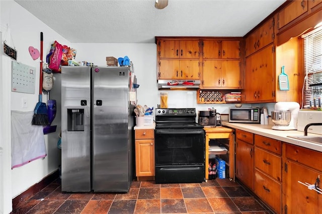 7703 Moorefield Memorial Hwy, Liberty, SC 29657 - kitchen with stainless steel appliances, ventilation hood, light countertops, brown cabinets, and a textured ceiling