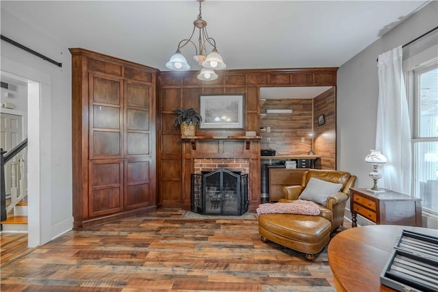 251 W Mcelhaney Rd, Taylors, SC 29687 - sitting room featuring wood finished floors, wood walls, a fireplace, a chandelier, and stairs