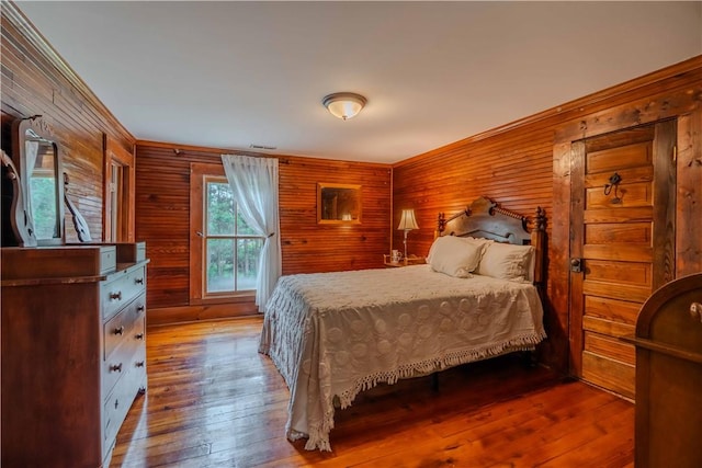 251 W Mcelhaney Rd, Taylors, SC 29687 - bedroom featuring wood walls, wood-type flooring, and crown molding