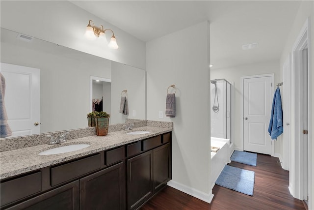 220 Celebration Ave, Anderson, SC 29625 - bathroom featuring a stall shower, wood finished floors, double vanity, and a bath