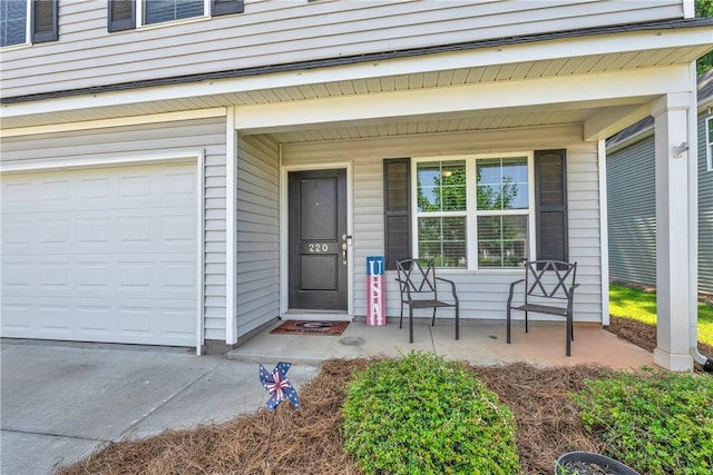 220 Celebration Ave, Anderson, SC 29625 - view of exterior entry with a porch, a garage, and concrete driveway