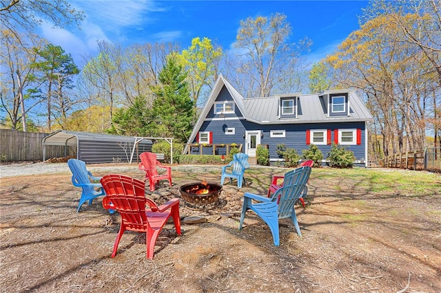 1047 Tranquility Ln, Hartwell, GA 30643 - rear view of house with an outdoor fire pit and a metal roof