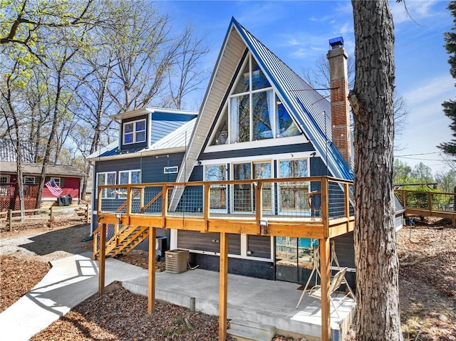 1047 Tranquility Ln, Hartwell, GA 30643 - back of property featuring stairway, a deck, a metal roof, a patio, and a chimney