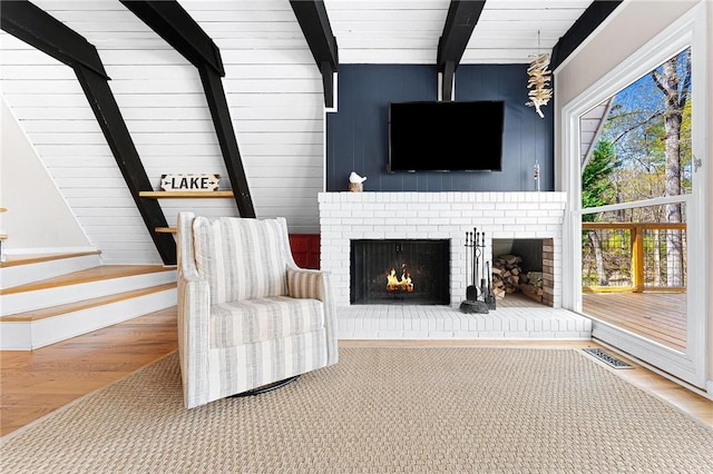 1047 Tranquility Ln, Hartwell, GA 30643 - living room featuring beamed ceiling, wood finished floors, and a fireplace