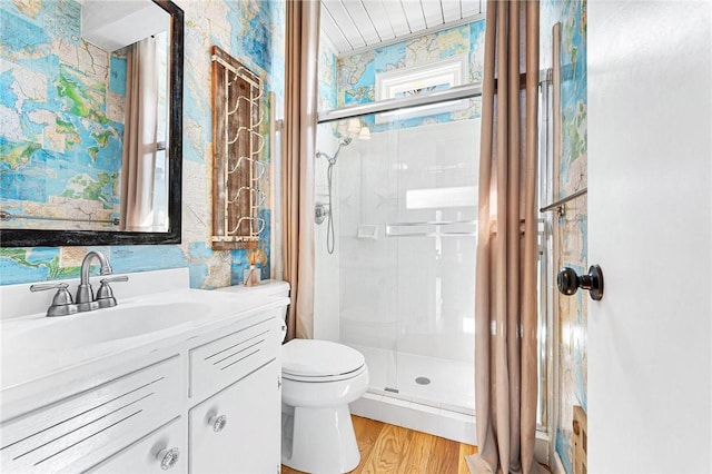 1047 Tranquility Ln, Hartwell, GA 30643 - bathroom featuring a shower stall, vanity, wallpapered walls, and wood finished floors
