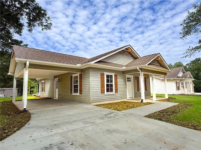 330 Code Cir, Seneca, SC 29678 - view of front facade with driveway, a carport, a porch, and roof with shingles