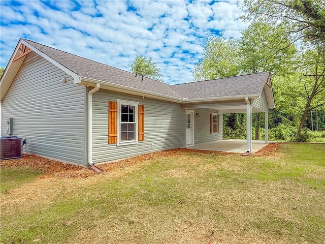 330 Code Cir, Seneca, SC 29678 - back of house featuring a patio, a lawn, roof with shingles, and an attached carport