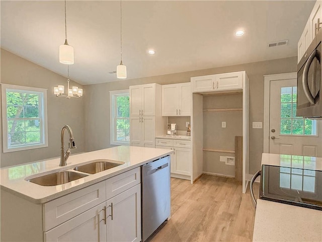330 Code Cir, Seneca, SC 29678 - kitchen with stainless steel dishwasher, lofted ceiling, white cabinetry, light countertops, and light wood-style flooring
