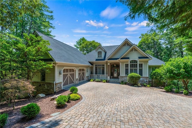 120 Links View Ct, Sunset, SC 29685 - craftsman inspired home featuring stone siding, covered porch, a garage, decorative driveway, and roof with shingles