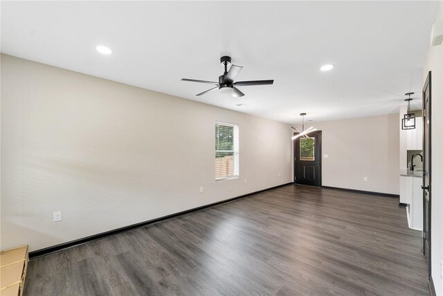 108 Hunter St, Anderson, SC 29625 - empty room with dark wood finished floors, ceiling fan, recessed lighting, and a chandelier