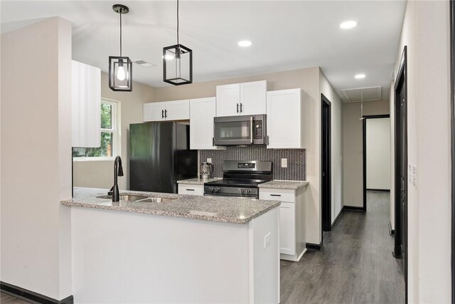 108 Hunter St, Anderson, SC 29625 - kitchen featuring appliances with stainless steel finishes, white cabinets, wood finished floors, a peninsula, and tasteful backsplash