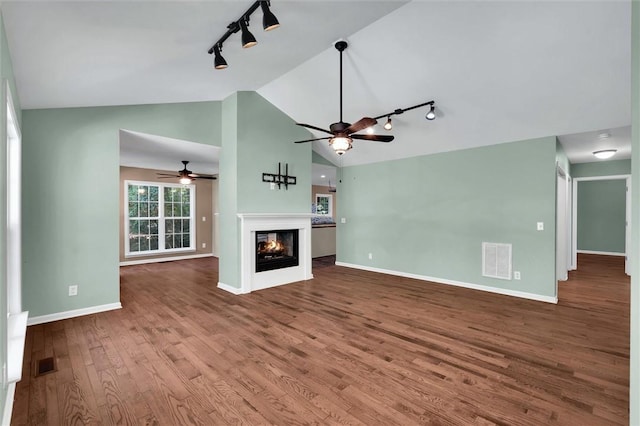 210 Briarcliff Rd, Central, SC 29630 - unfurnished living room featuring track lighting, ceiling fan, wood finished floors, a glass covered fireplace, and high vaulted ceiling