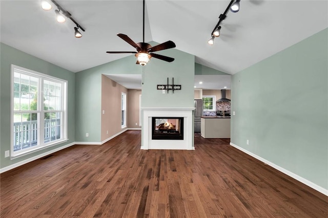 210 Briarcliff Rd, Central, SC 29630 - unfurnished living room with track lighting, lofted ceiling, ceiling fan, dark wood-style flooring, and plenty of natural light