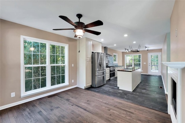 210 Briarcliff Rd, Central, SC 29630 - kitchen with stainless steel appliances, wall chimney exhaust hood, tasteful backsplash, dark wood-style floors, and a center island with sink