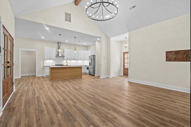 711 Concord Rd, Anderson, SC 29621 - unfurnished living room with a chandelier, high vaulted ceiling, wood finished floors, beamed ceiling, and recessed lighting