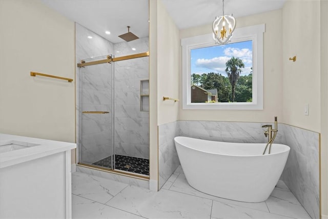 711 Concord Rd, Anderson, SC 29621 - full bath featuring marble look tiles, a marble finish shower, a soaking tub, a chandelier, and vanity