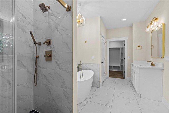 711 Concord Rd, Anderson, SC 29621 - full bath with marble look tile flooring, vanity, a marble finish shower, a freestanding tub, and a spacious closet