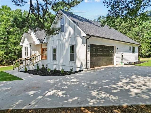 711 Concord Rd, Anderson, SC 29621 - view of home's exterior featuring roof with shingles, an attached garage, concrete driveway, and board and batten siding