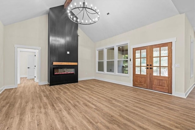 711 Concord Rd, Anderson, SC 29621 - unfurnished living room featuring high vaulted ceiling, a chandelier, light wood-style flooring, french doors, and a fireplace