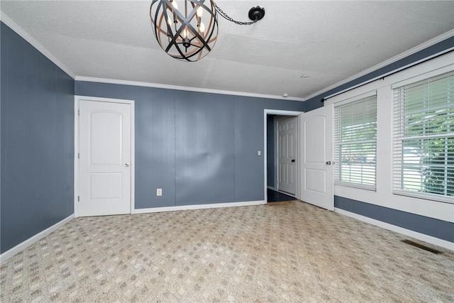 200 Maplecroft St, Liberty, SC 29657 - unfurnished room with crown molding, a chandelier, a textured ceiling, and carpet flooring
