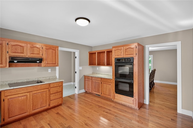 323 Indian Trl, Salem, SC 29676 - kitchen with black appliances, under cabinet range hood, and light wood-style flooring
