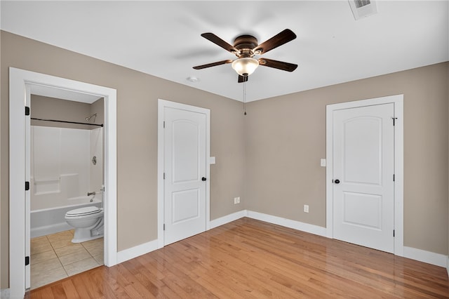 323 Indian Trl, Salem, SC 29676 - unfurnished bedroom with light wood-style flooring, connected bathroom, and ceiling fan