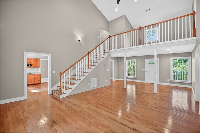323 Indian Trl, Salem, SC 29676 - unfurnished living room with high vaulted ceiling, light wood-style flooring, stairway, and ceiling fan