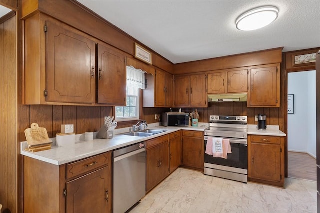 123 Radisson Rd, Seneca, SC 29678 - kitchen featuring appliances with stainless steel finishes, under cabinet range hood, brown cabinets, and light countertops