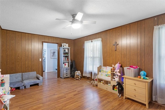 123 Radisson Rd, Seneca, SC 29678 - rec room with a ceiling fan, wood finished floors, a textured ceiling, and wooden walls