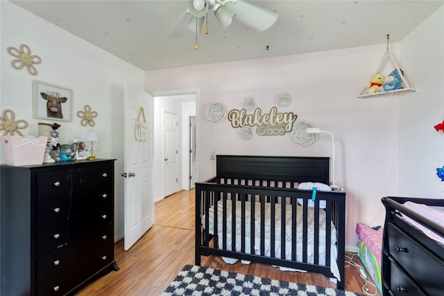 123 Radisson Rd, Seneca, SC 29678 - bedroom with wood finished floors, a nursery area, and ceiling fan
